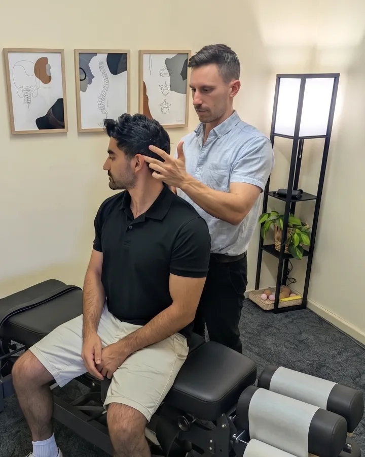 Dr Simon Hardy performing an assessment on a patient at Bassendean Chiropractic, Morley