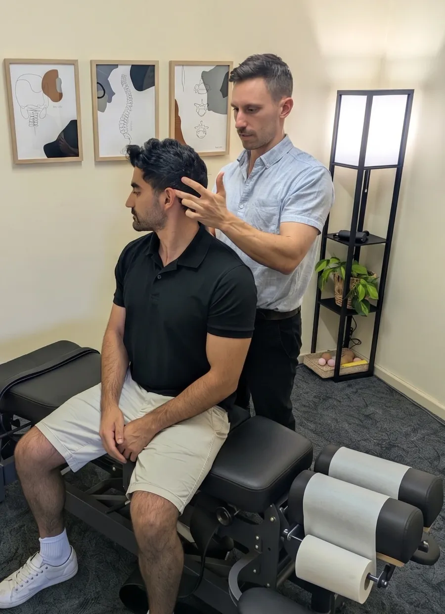 Dr Simon Hardy performing an assessment on a patient at Bassendean Chiropractic, Morley